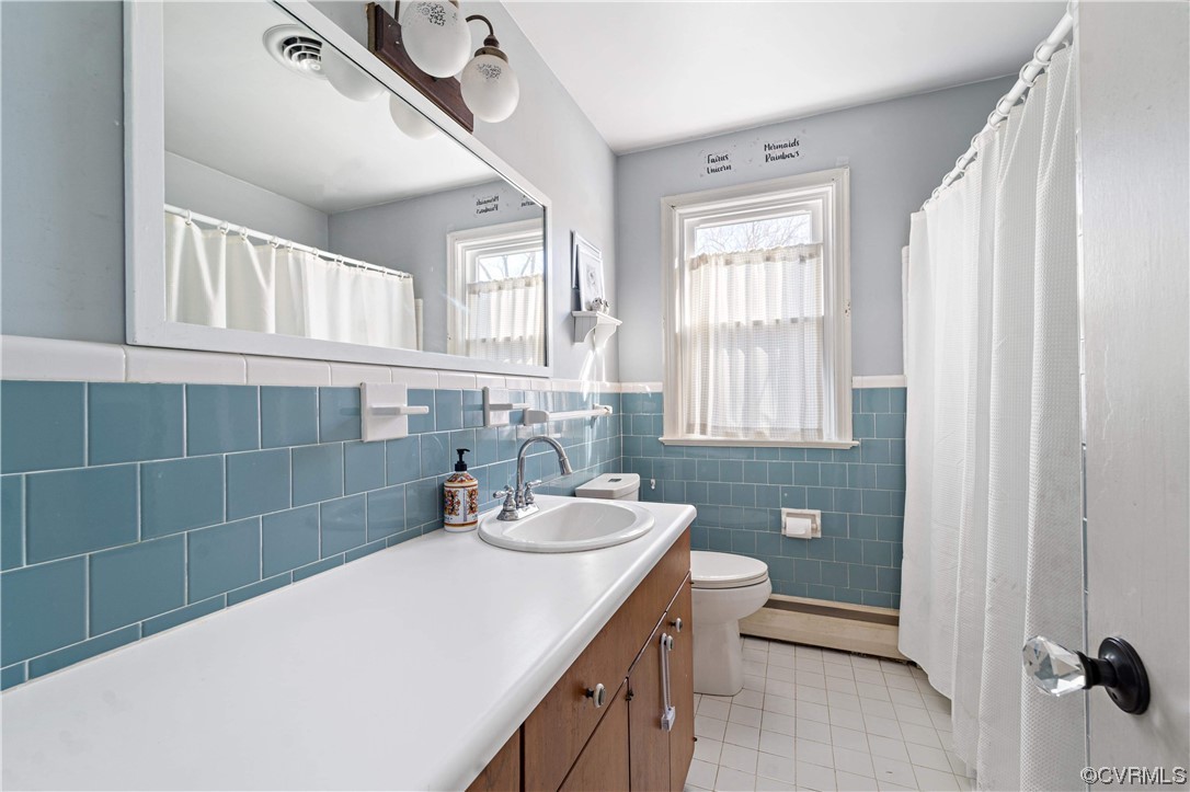 11533 Rolling Brook Road Chester, VA 23831 - Photo 16 of 30 a bathroom with a sink a toilet and shower