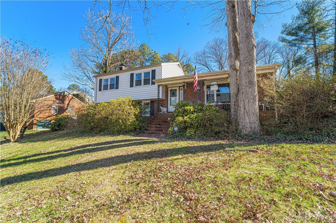 11533 Rolling Brook Road Chester, VA 23831 - Photo 2 of 30 a view of a brick house with a yard