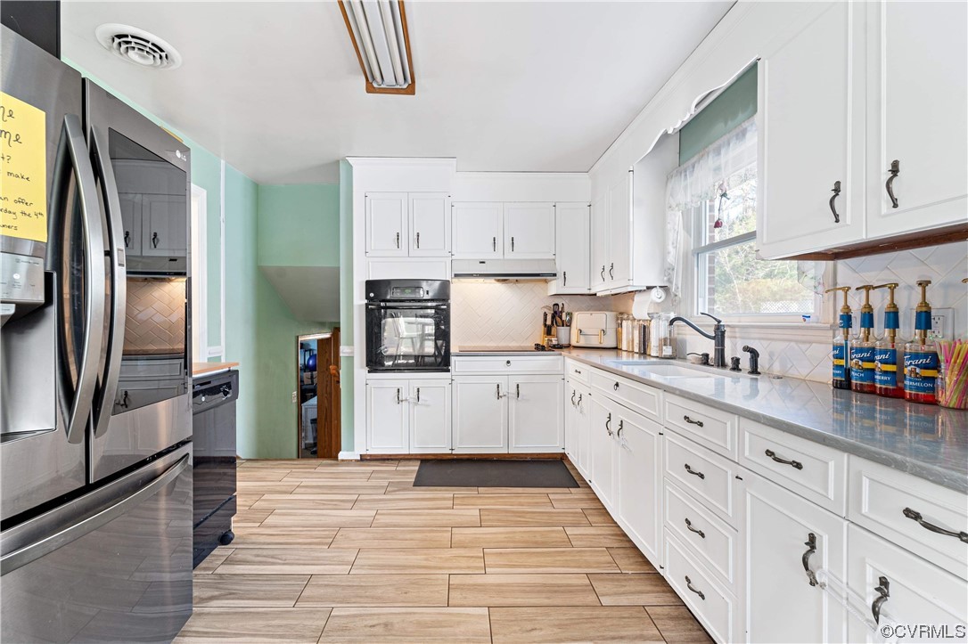 11533 Rolling Brook Road Chester, VA 23831 - Photo 6 of 30 a kitchen with granite countertop a refrigerator oven a sink dishwasher and white cabinets next to a window