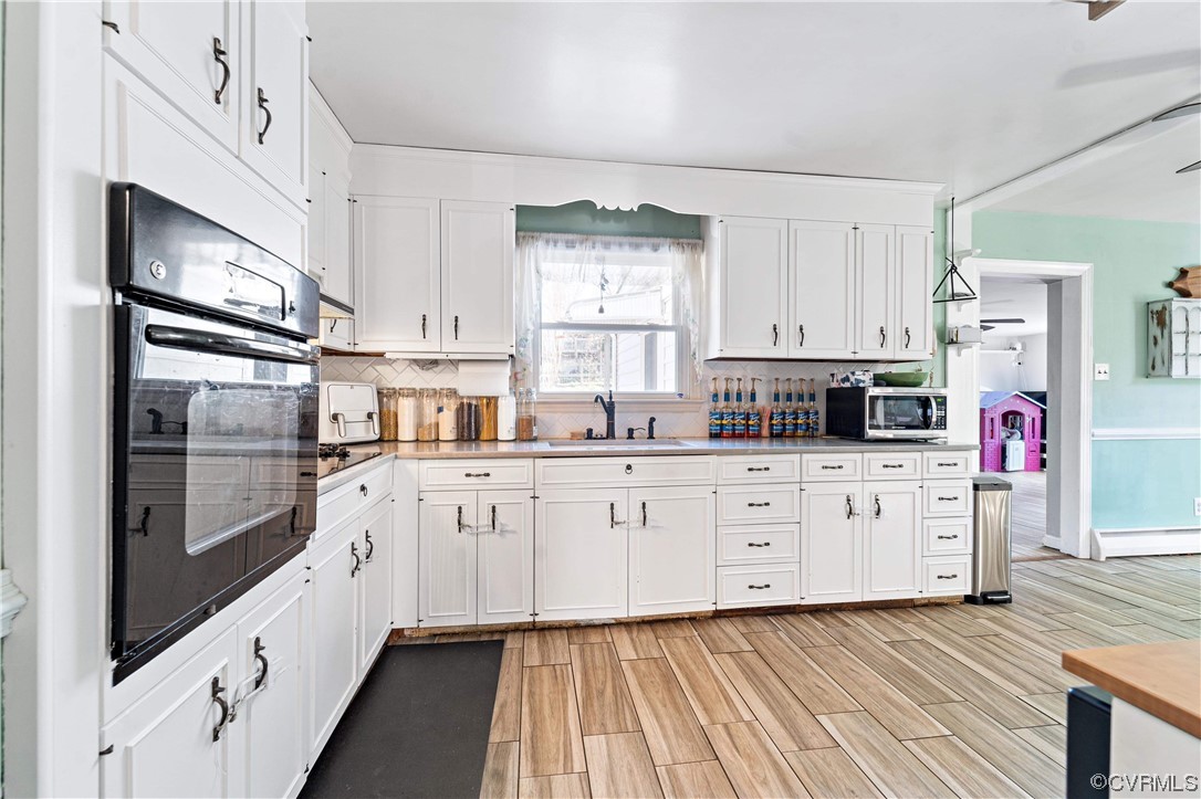 11533 Rolling Brook Road Chester, VA 23831 - Photo 7 of 30 a kitchen with stainless steel appliances granite countertop a refrigerator oven a sink dishwasher and white cabinets with wooden floor