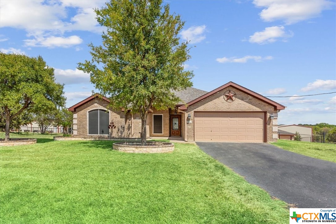 a front view of a house with a yard and garage