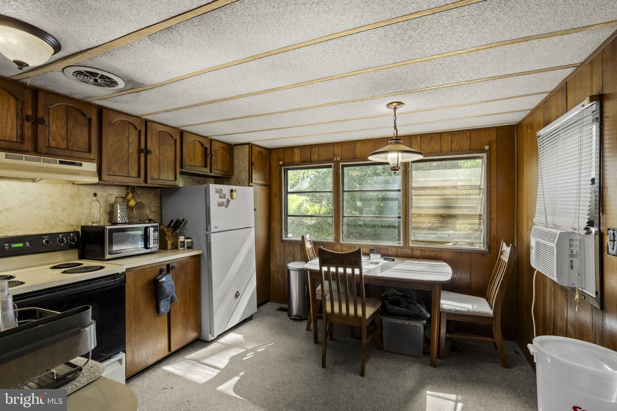 1528 Hilltop Road Mohnton, PA 19540 - Photo 10 of 19 a kitchen with refrigerator cabinets dining table and chairs