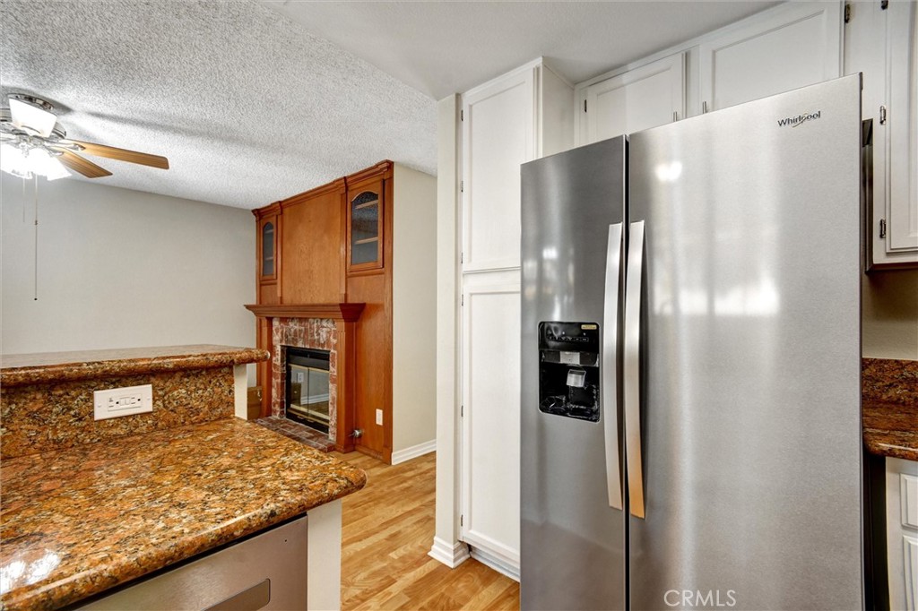 11024 Charleston Street Rancho Cucamonga, CA 91701 - Photo 4 of 30 a kitchen with stainless steel appliances granite countertop cabinets and refrigerator