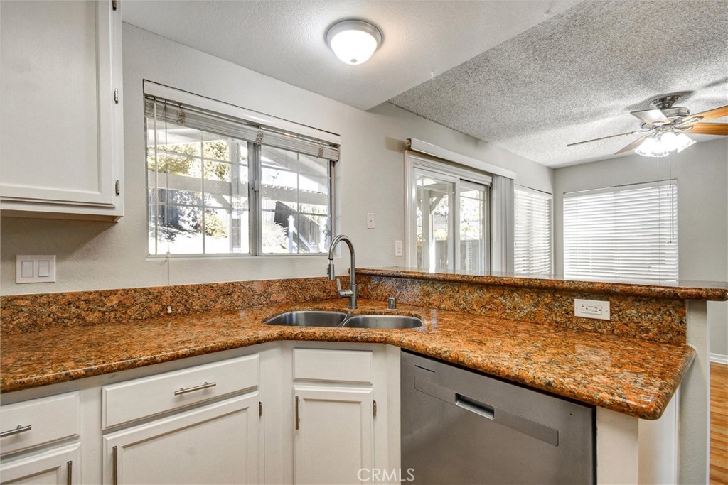 11024 Charleston Street Rancho Cucamonga, CA 91701 - Photo 5 of 30 a kitchen with granite countertop a sink and a window