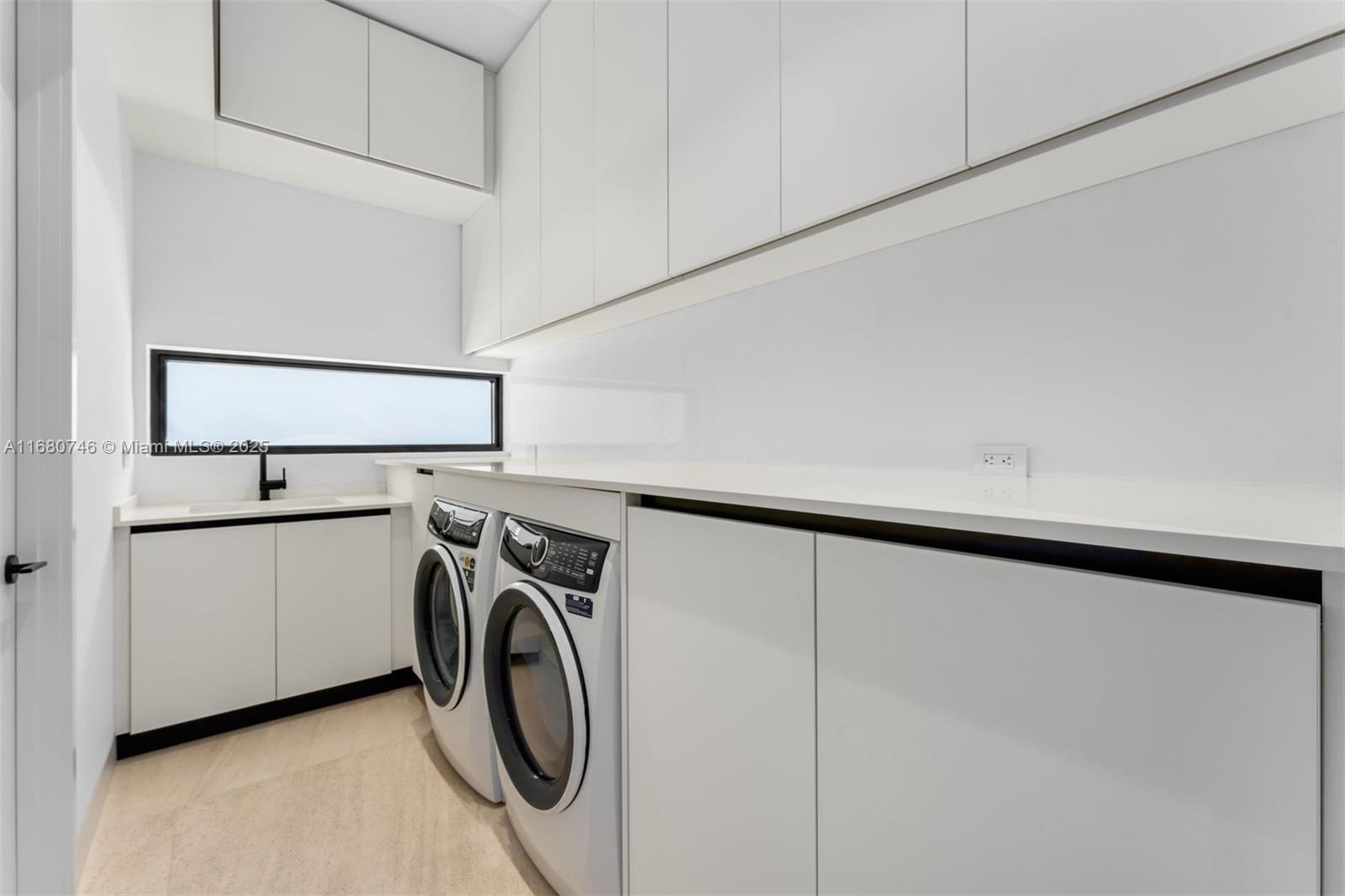 650 Warren Lane Key Biscayne, FL 33149 - Photo 18 of 34 a utility room with dryer and washer