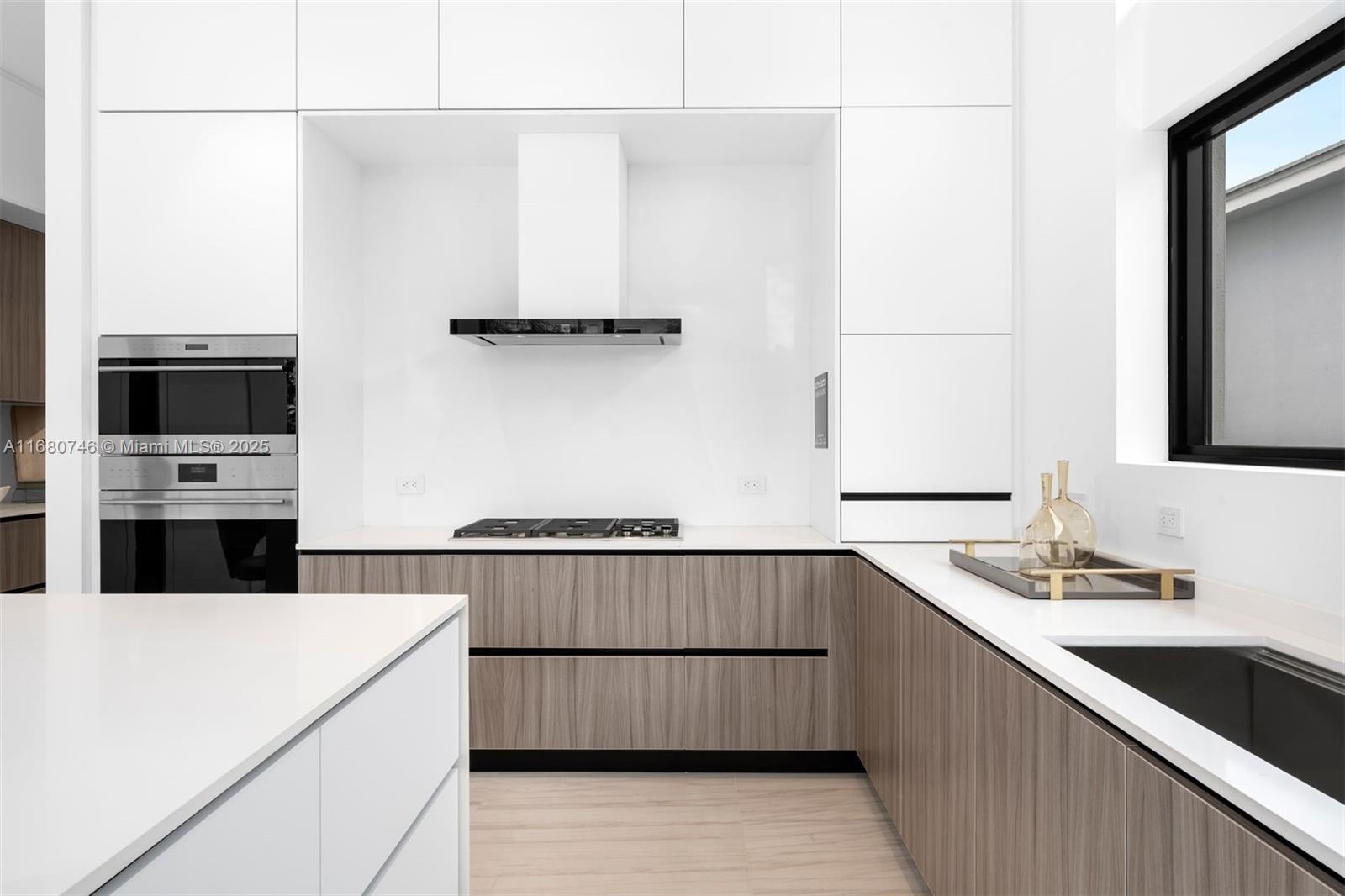 650 Warren Lane Key Biscayne, FL 33149 - Photo 20 of 34 a kitchen with stainless steel appliances a sink stove and cabinets