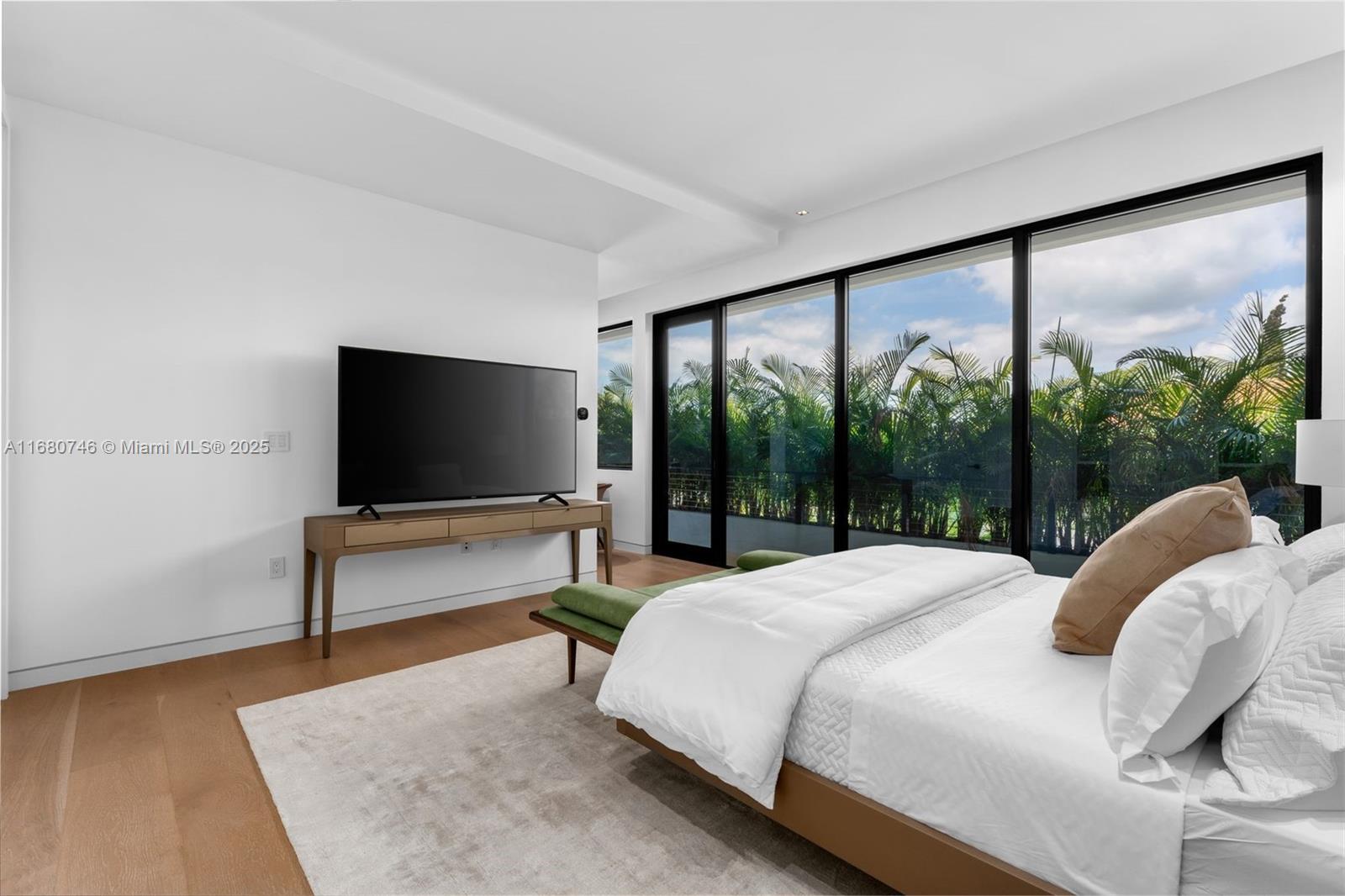 650 Warren Lane Key Biscayne, FL 33149 - Photo 23 of 34 a bedroom with a bed and large window