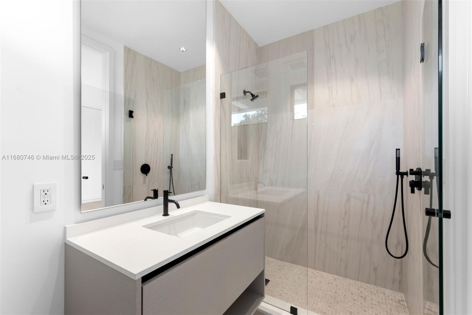 650 Warren Lane Key Biscayne, FL 33149 - Photo 30 of 34 a bathroom with a sink mirror and shower