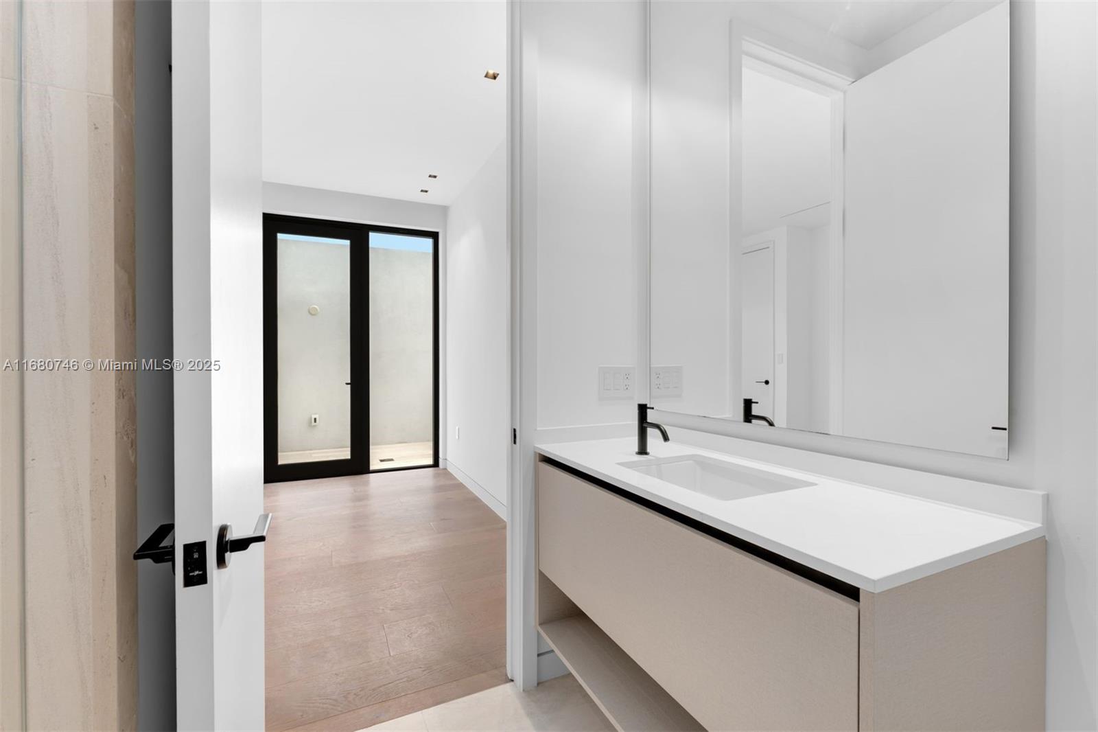 650 Warren Lane Key Biscayne, FL 33149 - Photo 33 of 34 a bathroom with a sink and a mirror