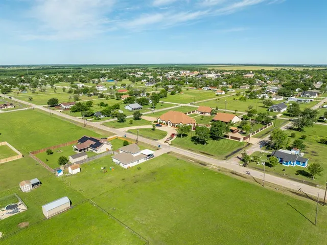 a view of green field with house in the background