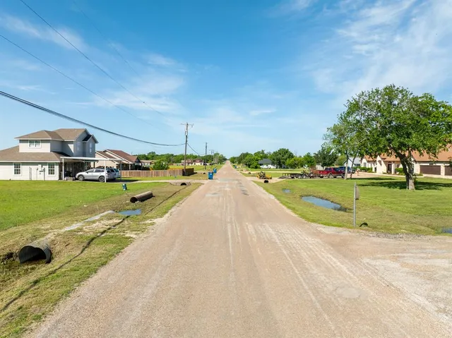 a view of swimming pool is middle in the garden