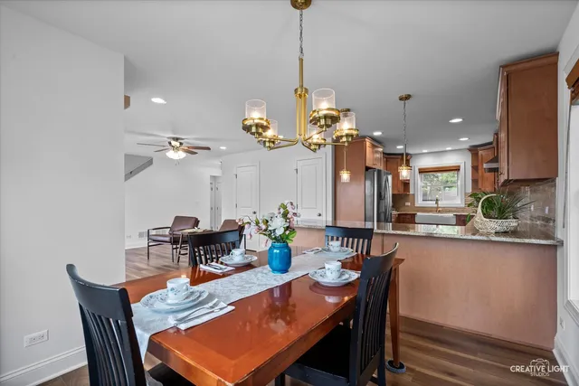 a dining room filled with furniture and a chandelier