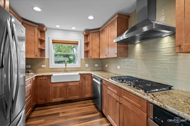 a kitchen with granite countertop a sink stainless steel appliances and cabinets