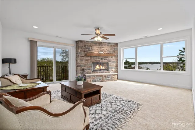 a living room with furniture and floor to ceiling windows