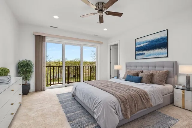 a bedroom with a large bed and a balcony