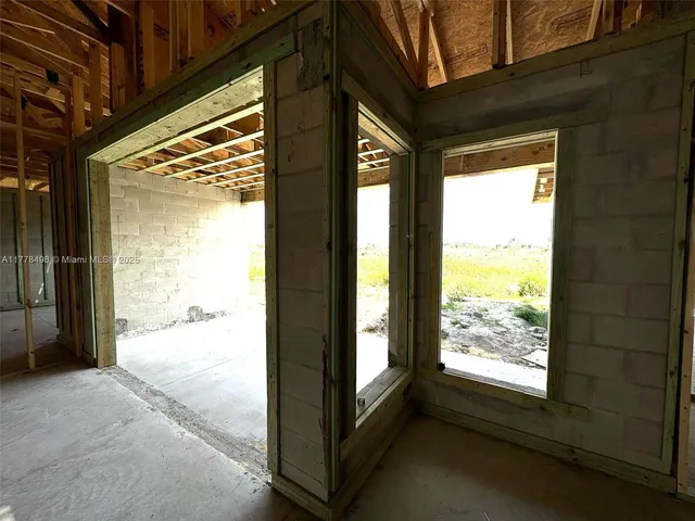 a view of an empty room and a window