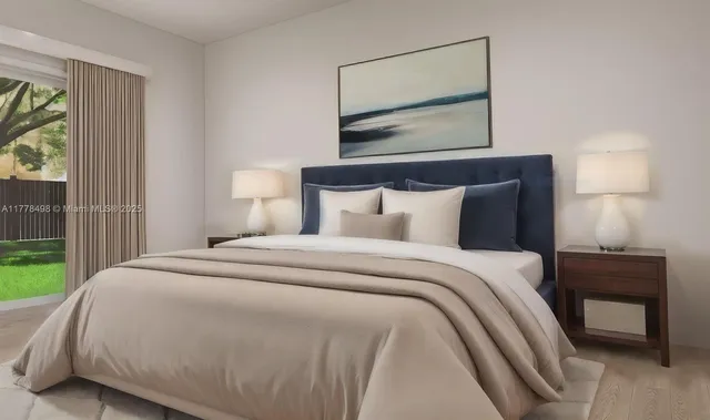 a bedroom with a bed and a lamp on dresser