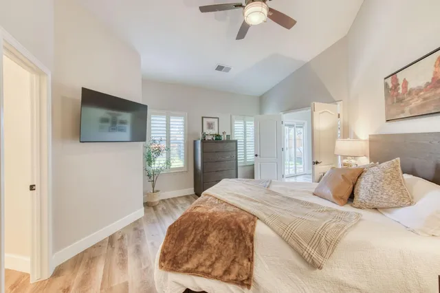 a bedroom with a large bed and a chandelier