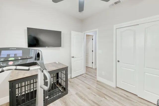 a view of a workspace with furniture and a flat screen tv