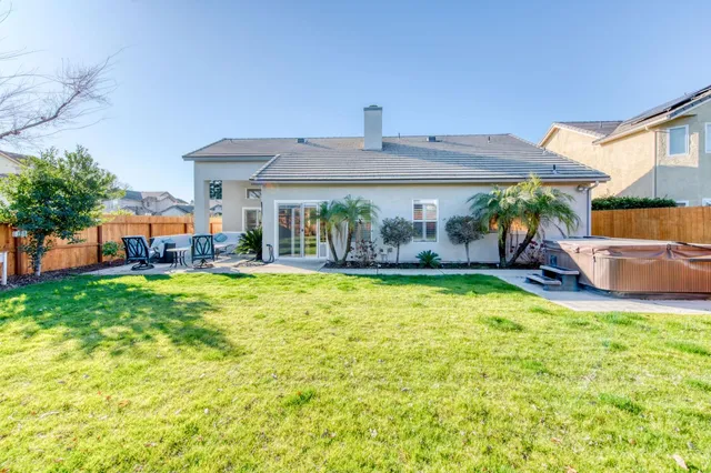 a front view of a house with swimming pool having outdoor seating