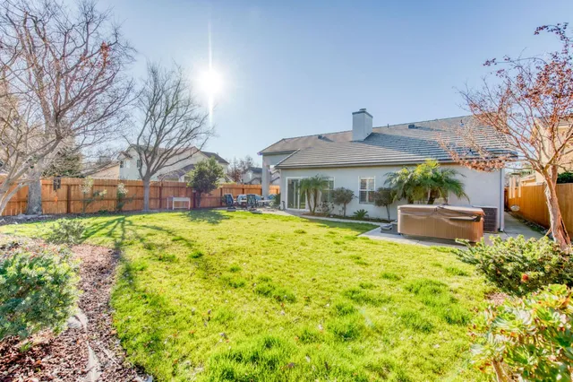 a house view with swimming pool in front of it
