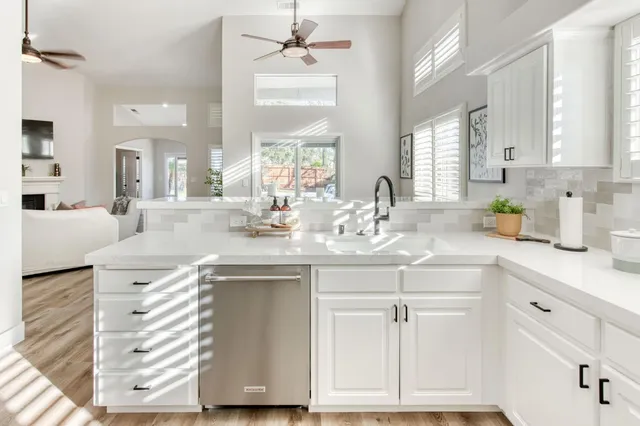 a kitchen with a sink window and cabinets