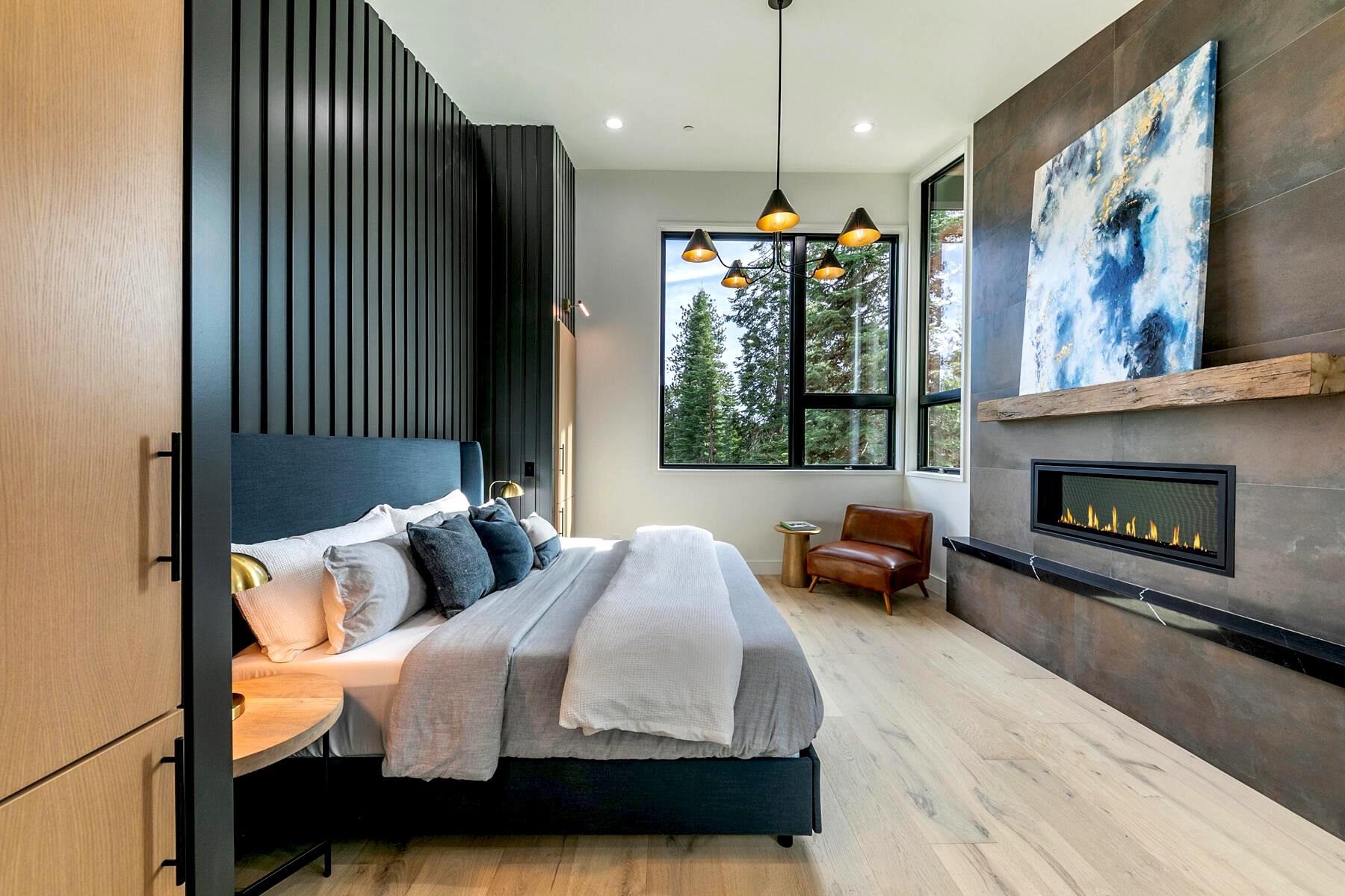 9291 Brae Road Truckee, CA 96161 - Photo 11 of 21 a bedroom with a bed and a fireplace