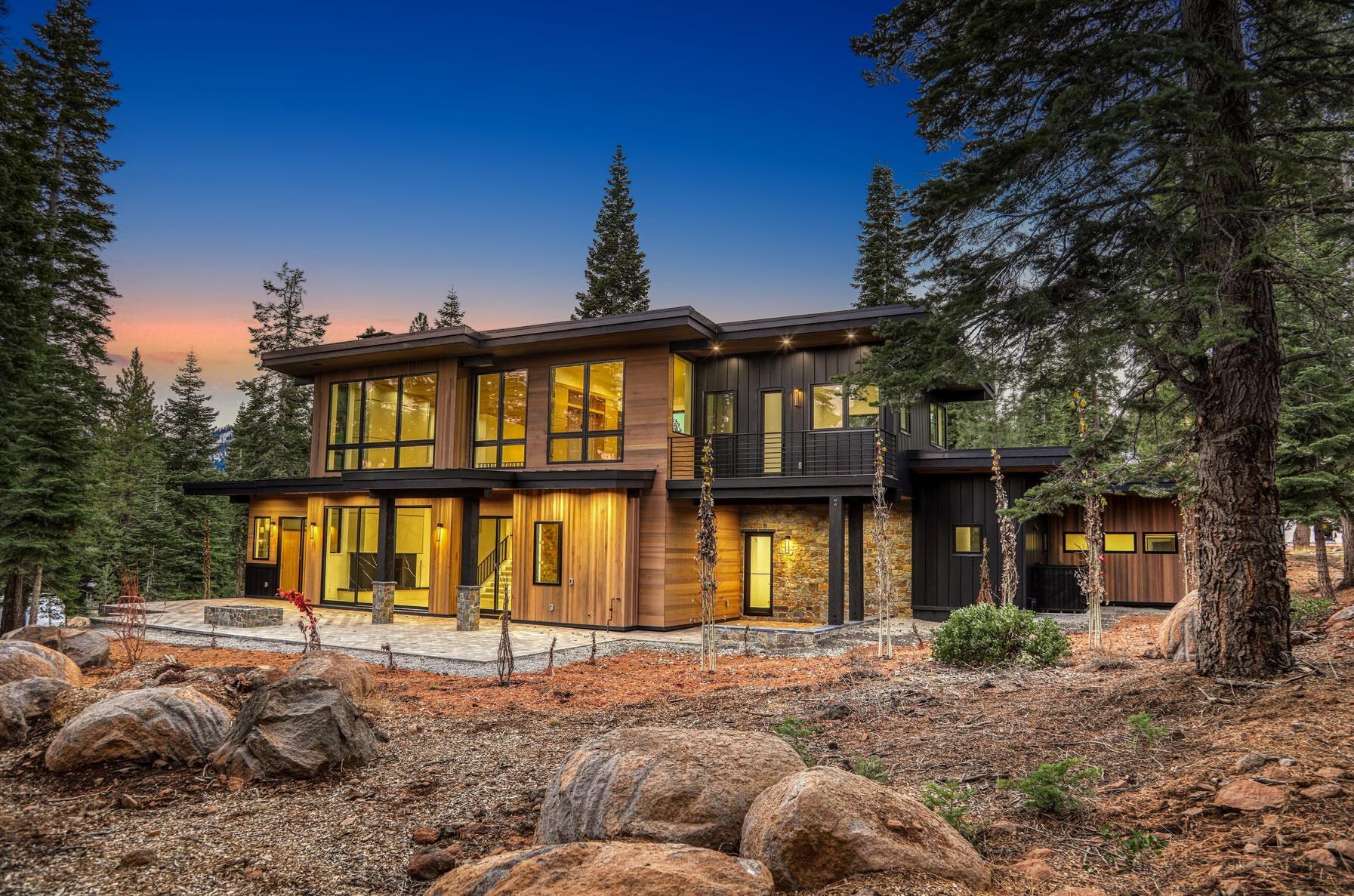 9291 Brae Road Truckee, CA 96161 - Photo 19 of 21 a view of a house with large windows and a yard