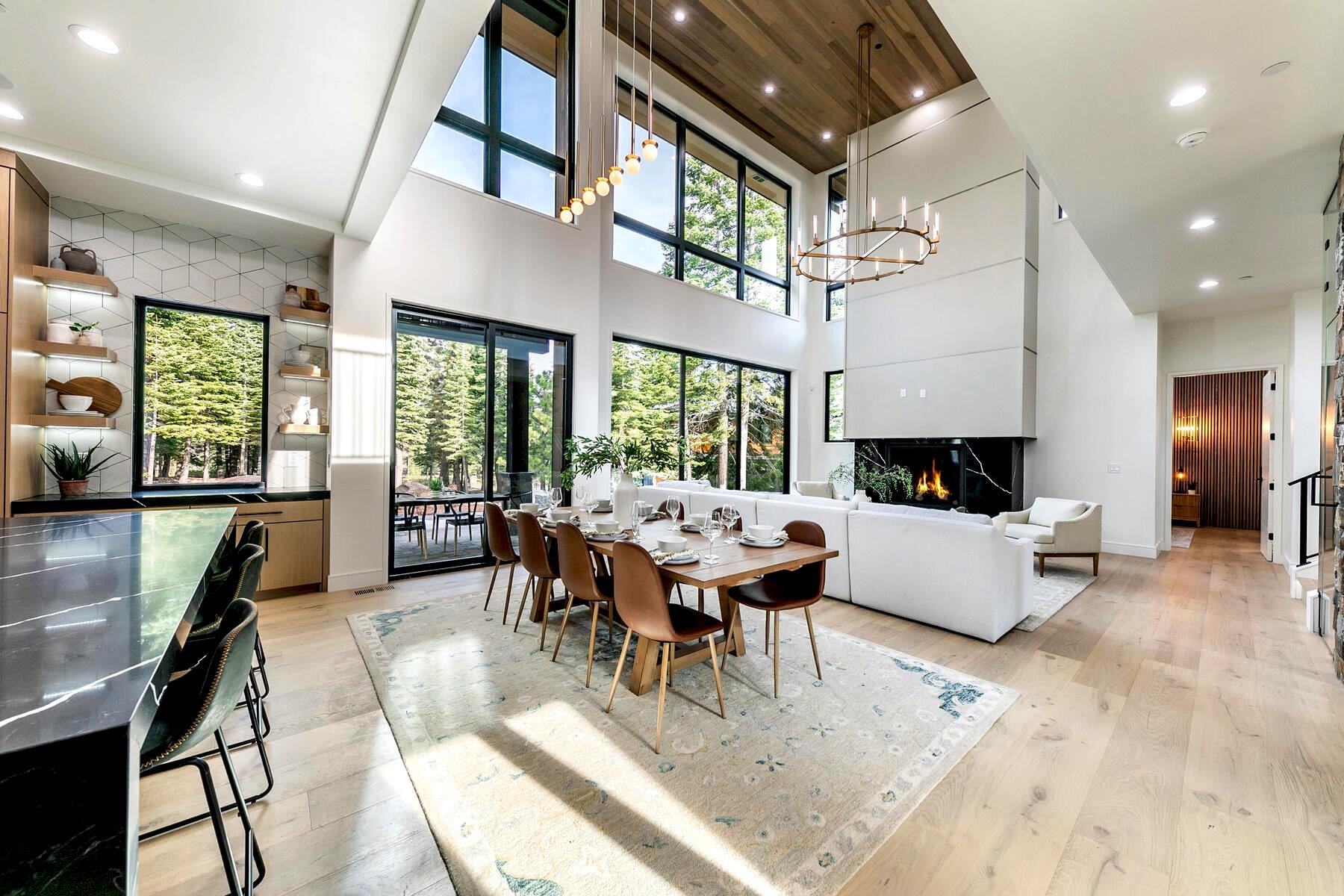9291 Brae Road Truckee, CA 96161 - Photo 2 of 21 a living room with furniture a fireplace and large windows