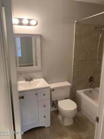 a bathroom with a sink a toilet and mirror