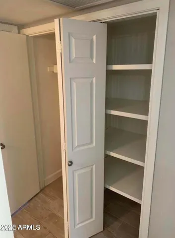 a view of walk in closet with empty racks