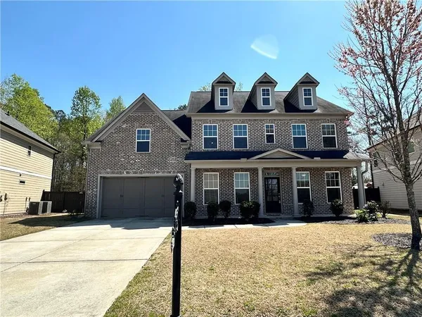 a front view of a house with a yard