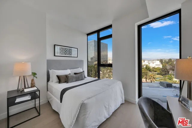 a bedroom with a bed and a night stand