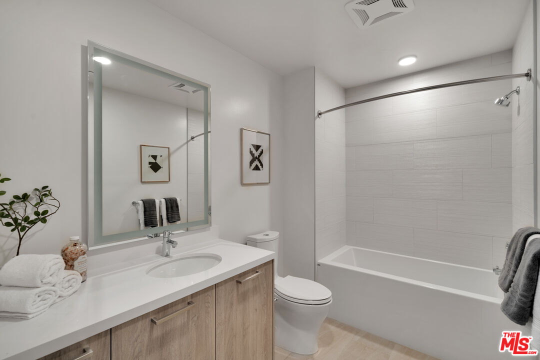 2801 Sunset Place, Unit 1911 Los Angeles, CA 90005 - Photo 7 of 18 a bathroom with a granite countertop sink toilet and shower