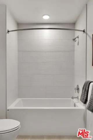 a bathroom with a bathtub and a shower
