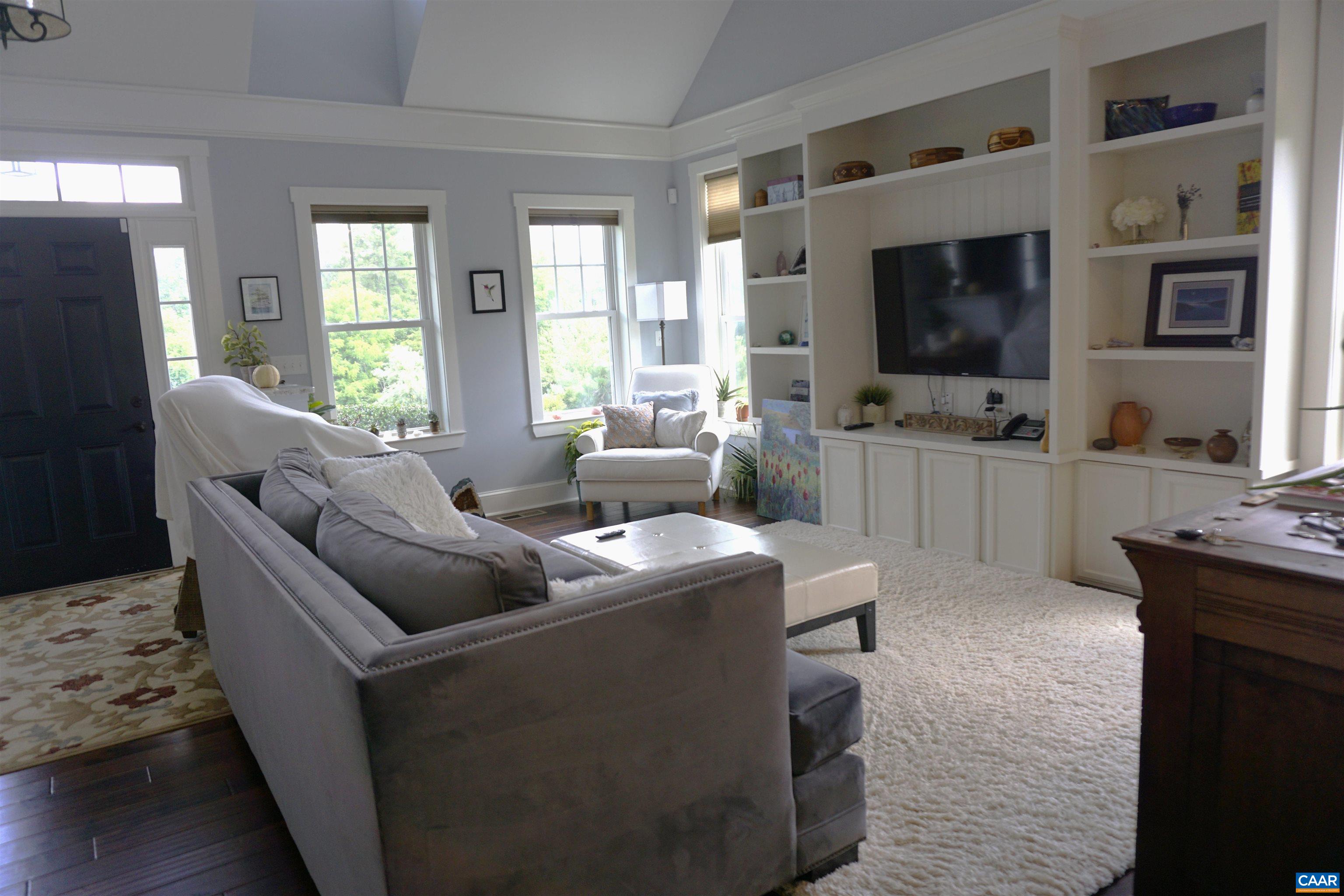 266 Ridgeview Drive Ruckersville, VA 22968 - Photo 8 of 20 a living room with furniture a flat screen tv and a fireplace