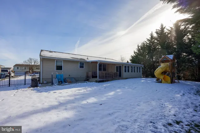 a front view of a house with a garden and trees