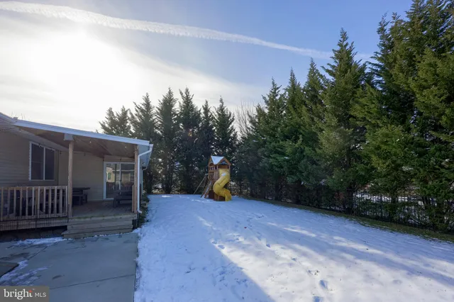 a view of a roof deck with wooden floor and outdoor seating