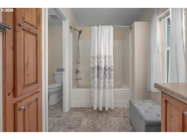 a bathroom with a shower and a tub