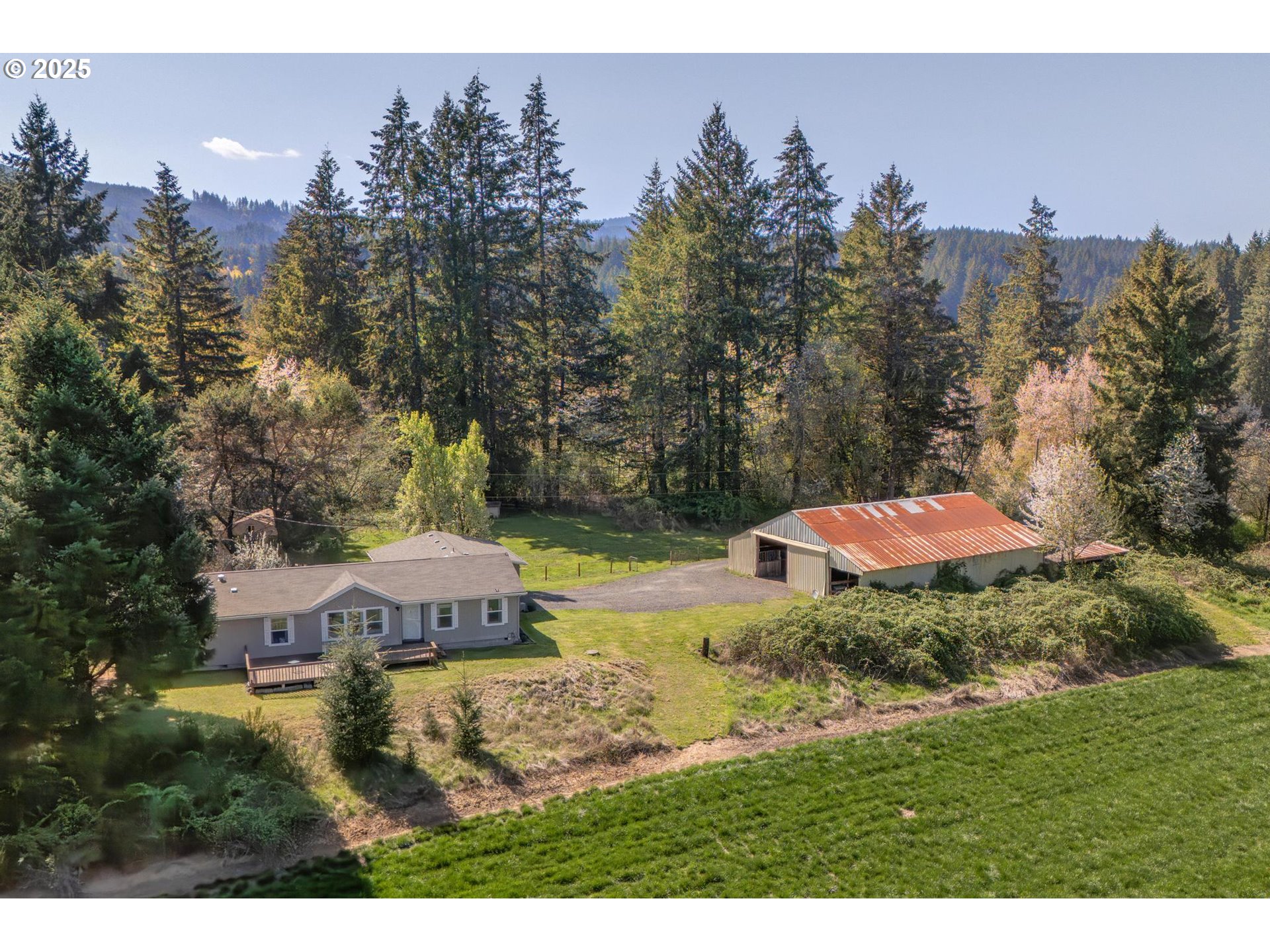 20270 Northwest Pihl Road Banks, OR 97106 - Photo 3 of 43 a aerial view of a house with a yard and lake view