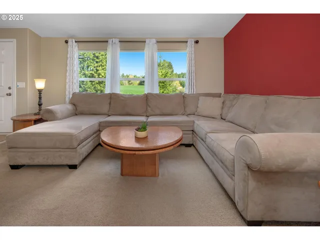 a living room with furniture and a large window