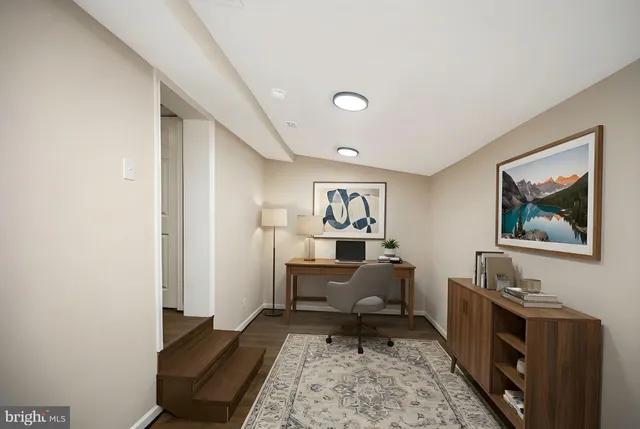 a living room with furniture and a rug