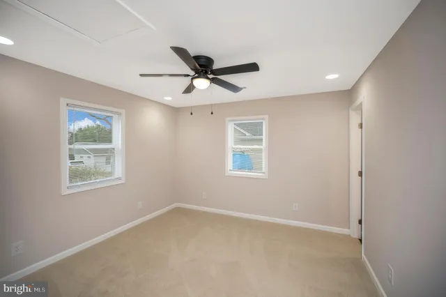 a view of a livingroom with a ceiling fan and window
