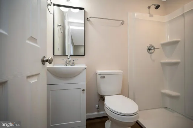 a white toilet sitting next to a bathroom sink