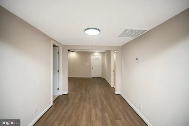 a view of a room with wooden floor