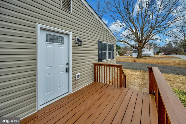 a view of a house with wooden deck