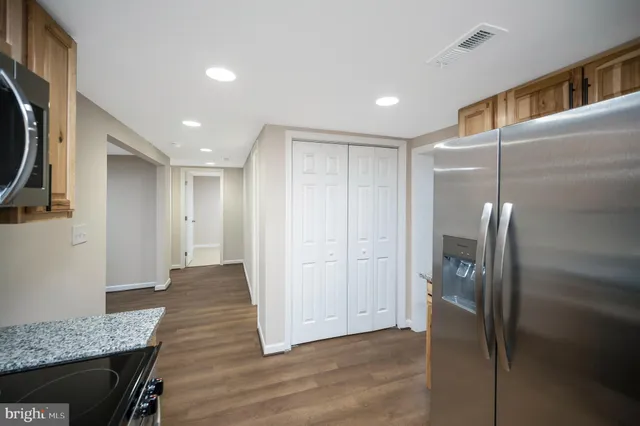 a view of a hallway with wooden floor