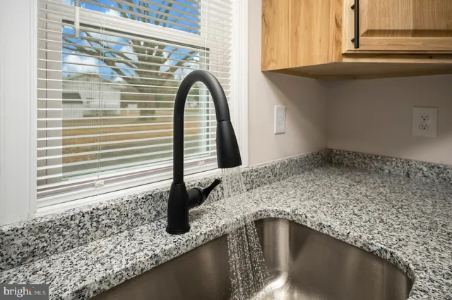 a close view of a sink a faucet and a window