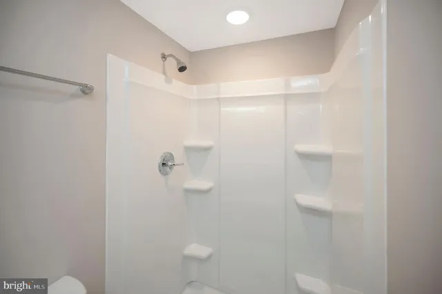 a bathroom with a shower a toilet and sink