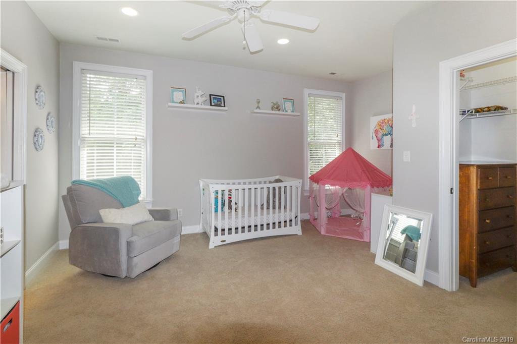 3458 Blue Jay Pass Fort Mill, SC 29708 - Photo 23 of 33 a spacious bedroom with a bed and a couch